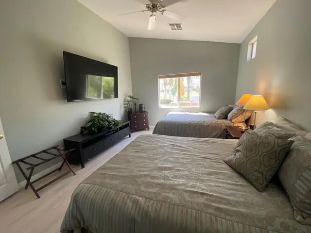 a bedroom with a bed and a flat screen tv