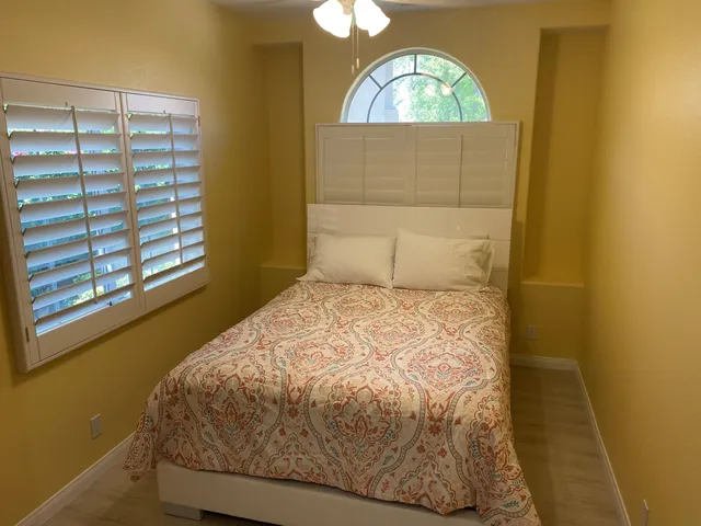 a bedroom with a bed and a window