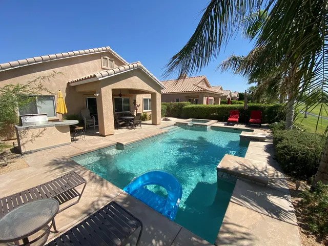 a view of a house with backyard and porch