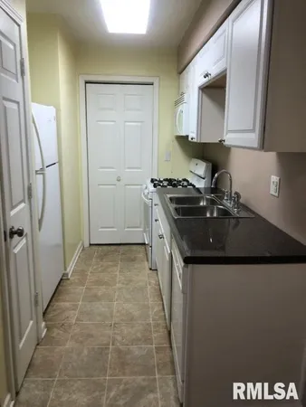 a kitchen with stainless steel appliances granite countertop a sink and a stove top oven