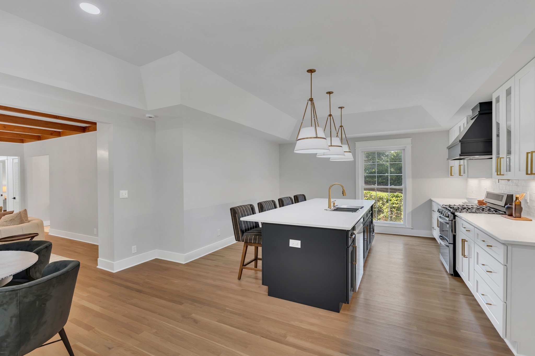 608 Hill Road Nashville, TN 37220 - Photo 18 of 44 a room with stainless steel appliances kitchen island a table chairs in it and wooden floors