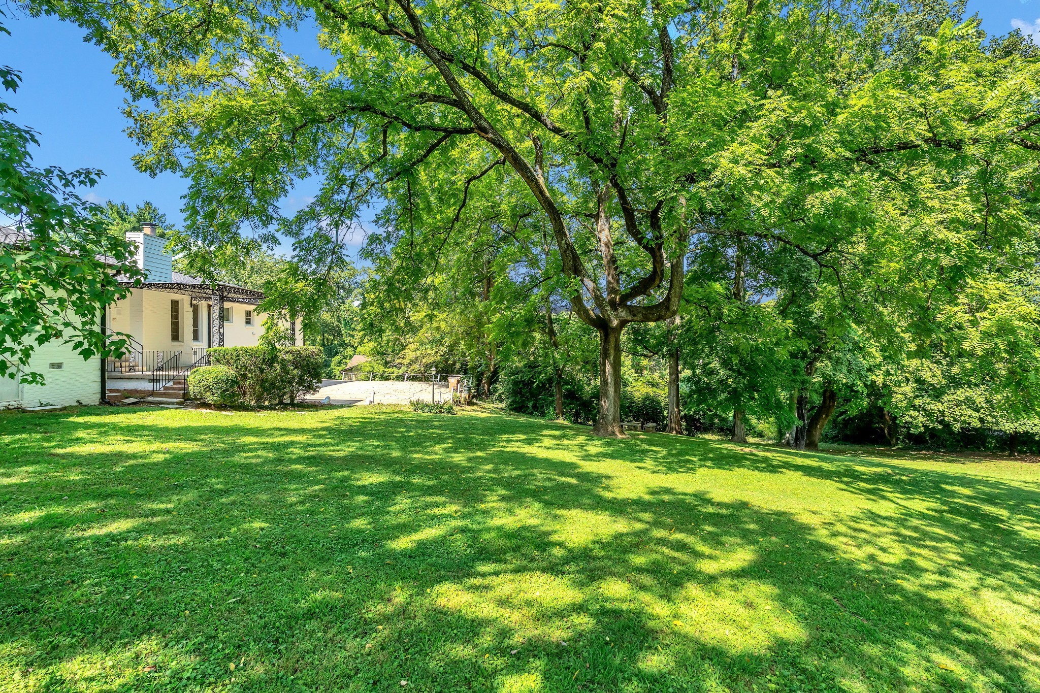 608 Hill Road Nashville, TN 37220 - Photo 10 of 44 a view of a house with a big yard and palm trees