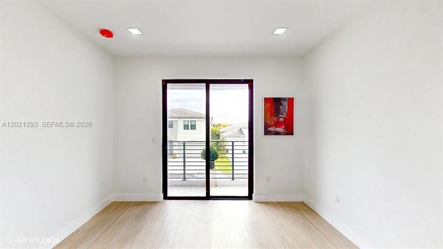 8350 Royal County Down Road Boca Raton, FL 33434 - Photo 28 of 52 a view of an empty room with wooden floor and a window