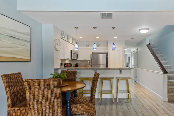a kitchen with stainless steel appliances granite countertop a refrigerator and a stove top oven