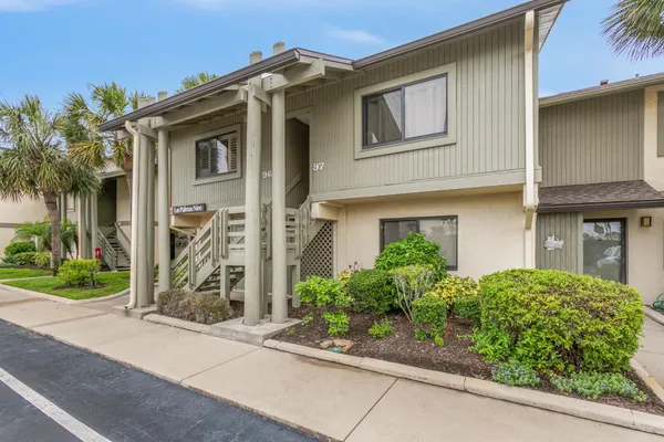 a view of a hallway with wooden floor fireplace and living room