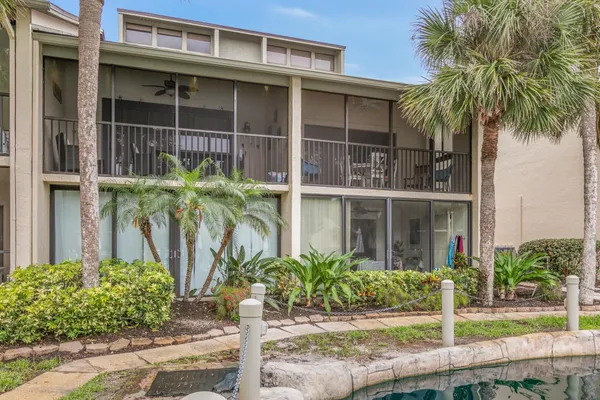 a view of a swimming pool with a patio and a yard