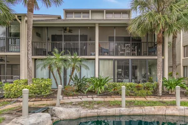 a view of a house with backyard porch and sitting area