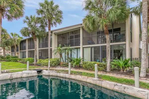a view of a house with pool and a yard