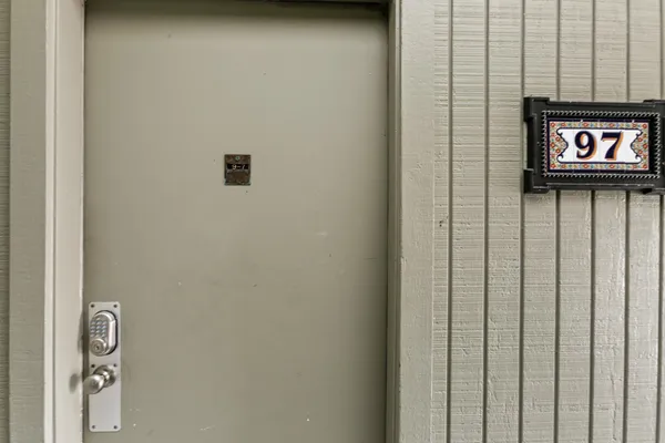 a bedroom with a granite countertop sink and a large mirror
