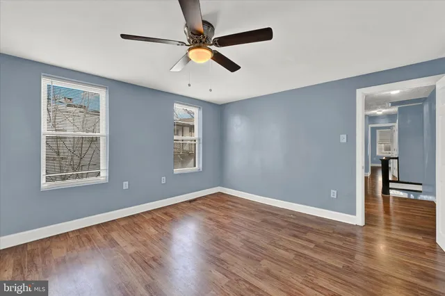 wooden floor in an empty room with a window