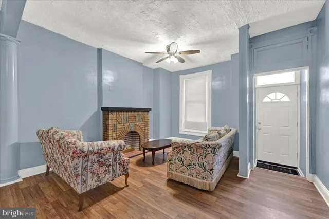 a living room with furniture and a fireplace