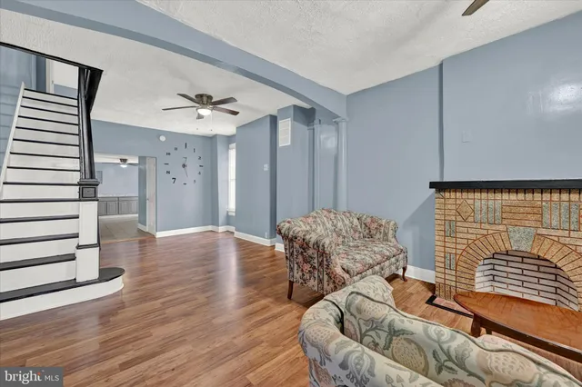 a living room with furniture and wooden floor