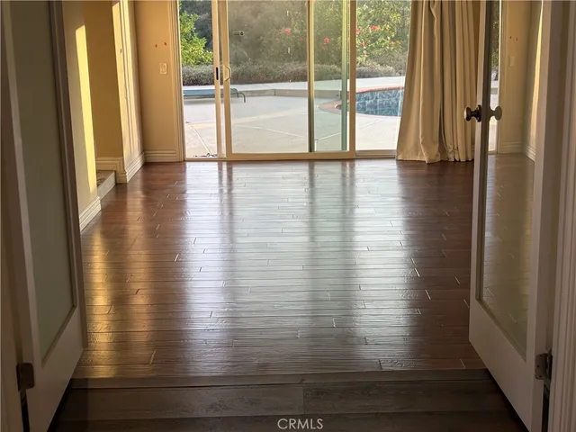 a view of an entryway with wooden floor
