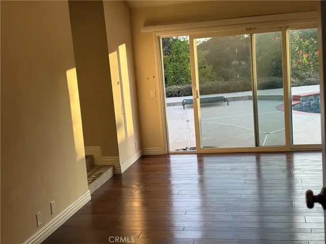 a view of room with window and wooden floor