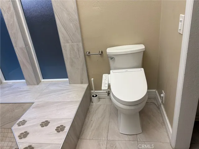 a white toilet sitting next to a white sink