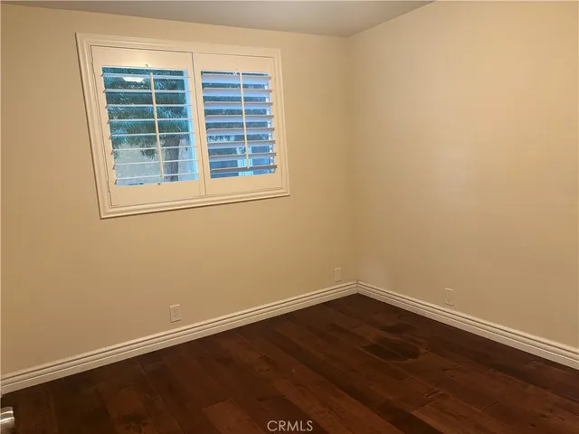 a view of a small space with wooden floor and a window