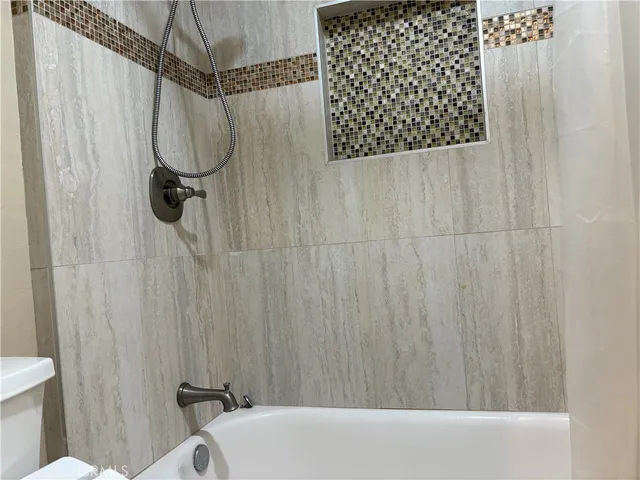 a bathroom with a shower curtain and a toilet