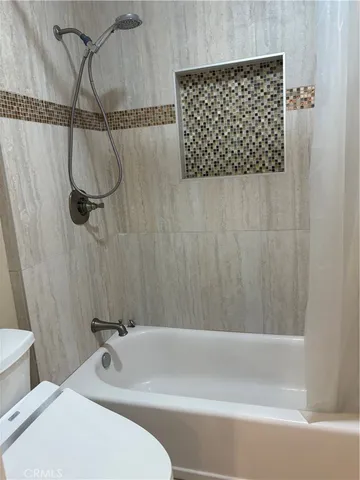 a bathroom with a bathtub and shower