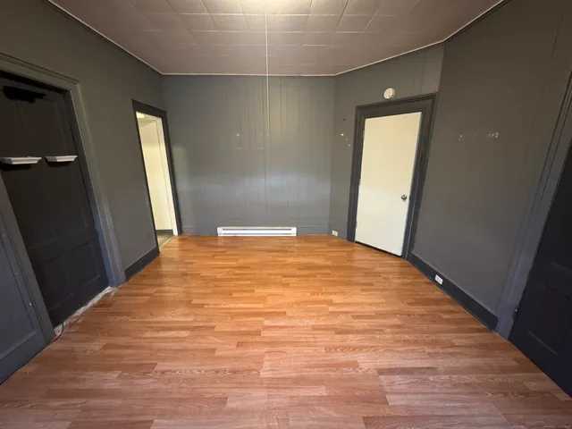 a bedroom with a bed and a mirror