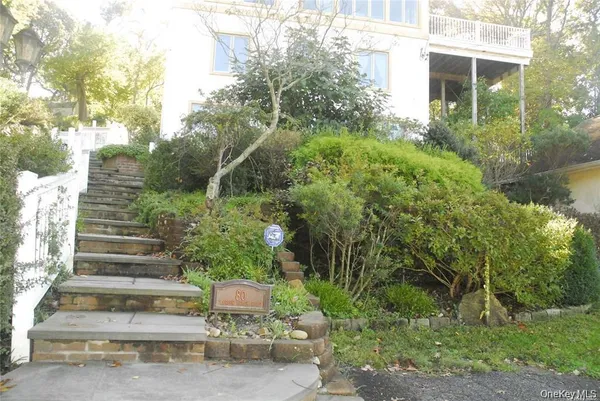 a view of a garden with large trees