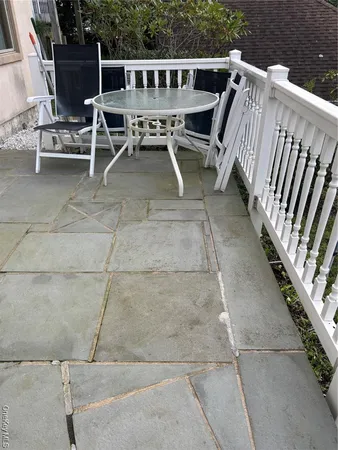 a view of deck with chairs and wooden fence