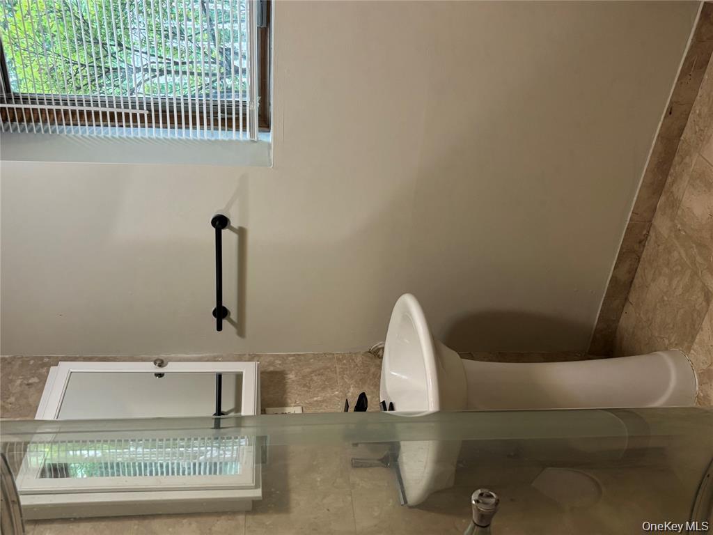 80 Harbor Beach Road Miller Place, NY 11764 - Photo 4 of 10 a bathroom with a sink and a mirror