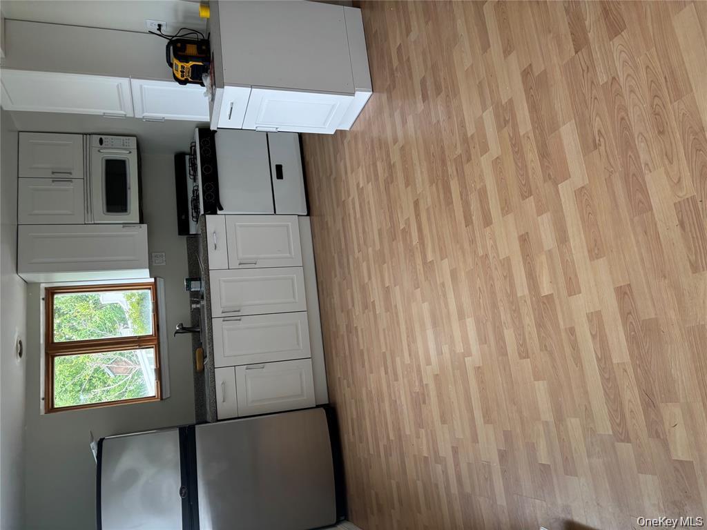 80 Harbor Beach Road Miller Place, NY 11764 - Photo 5 of 10 a kitchen with granite countertop a refrigerator and a stove top oven