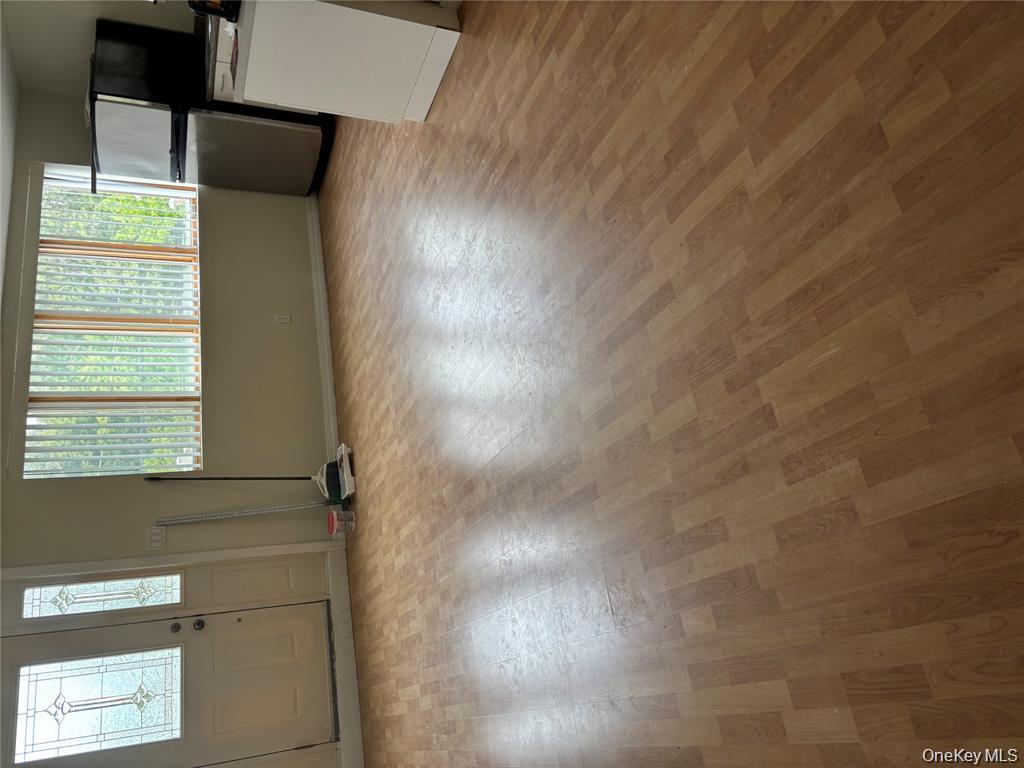 80 Harbor Beach Road Miller Place, NY 11764 - Photo 7 of 10 an empty room with wooden floor and windows