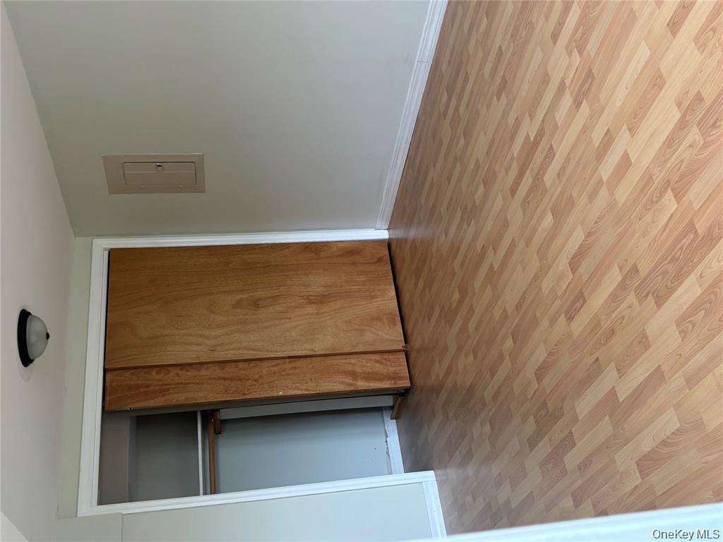 80 Harbor Beach Road Miller Place, NY 11764 - Photo 10 of 10 a view of an empty room with wooden floor and closet