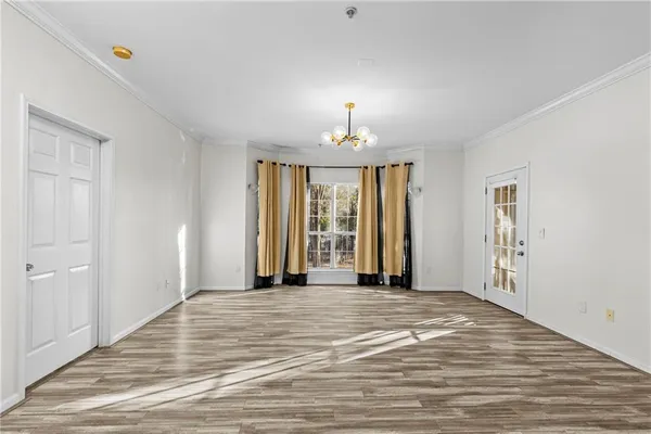 a view of a room with a windows and ceiling fan
