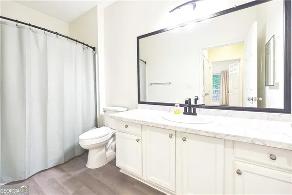 a bathroom with a sink a toilet and a mirror