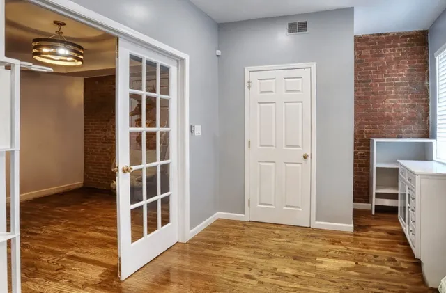 a view of a livingroom with a fireplace and a window