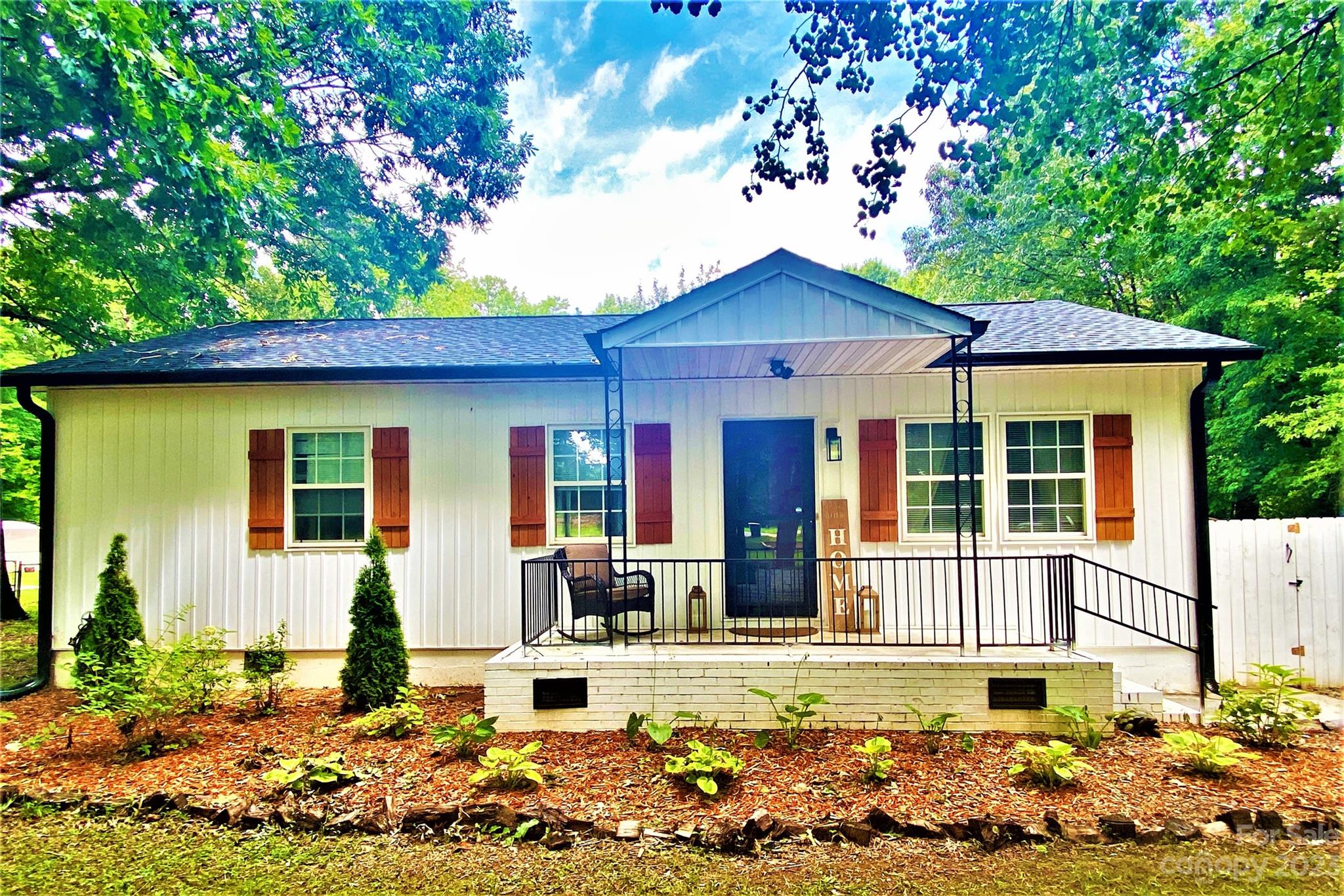 a front view of a house with garden