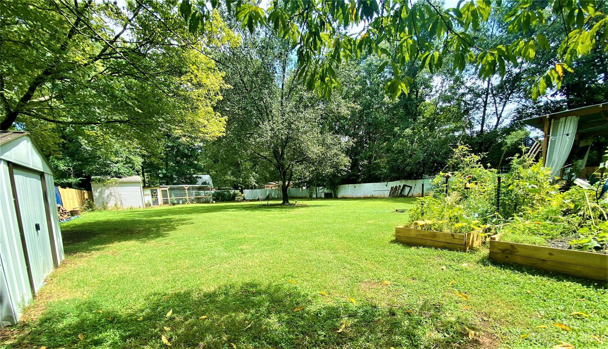 9701 Hambright Road Huntersville, NC 28078 - Photo 13 of 17 a view of a garden with a tree