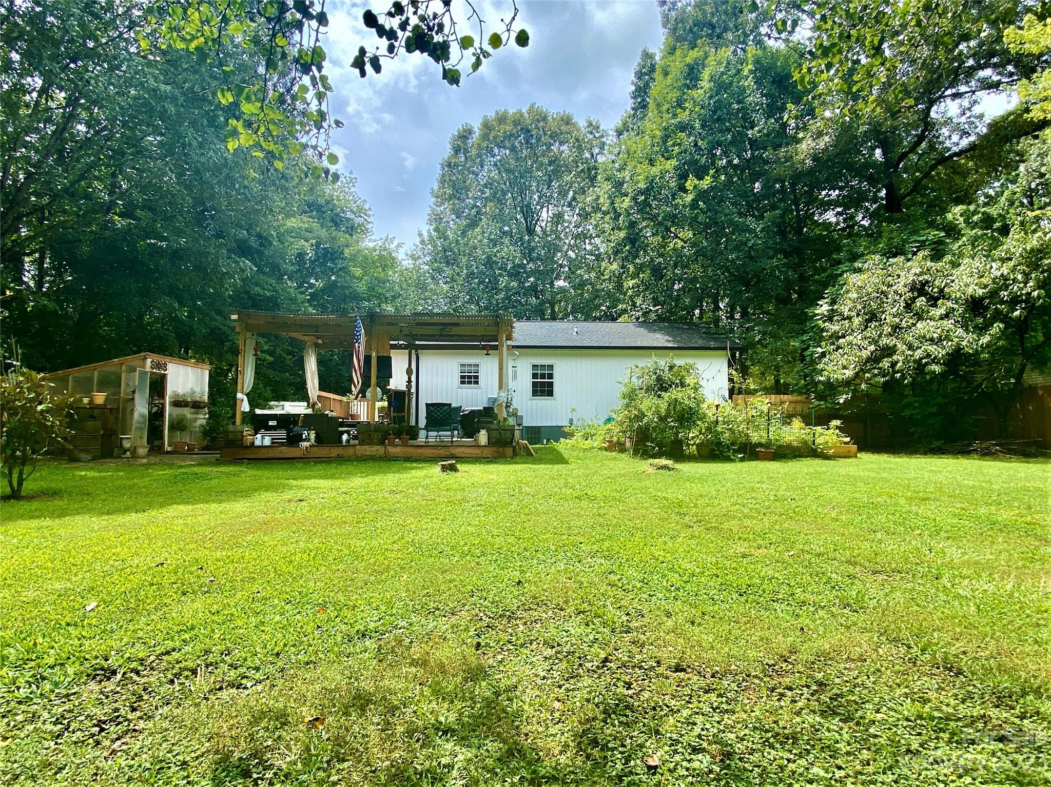 9701 Hambright Road Huntersville, NC 28078 - Photo 14 of 17 a front view of a house with a garden and trees