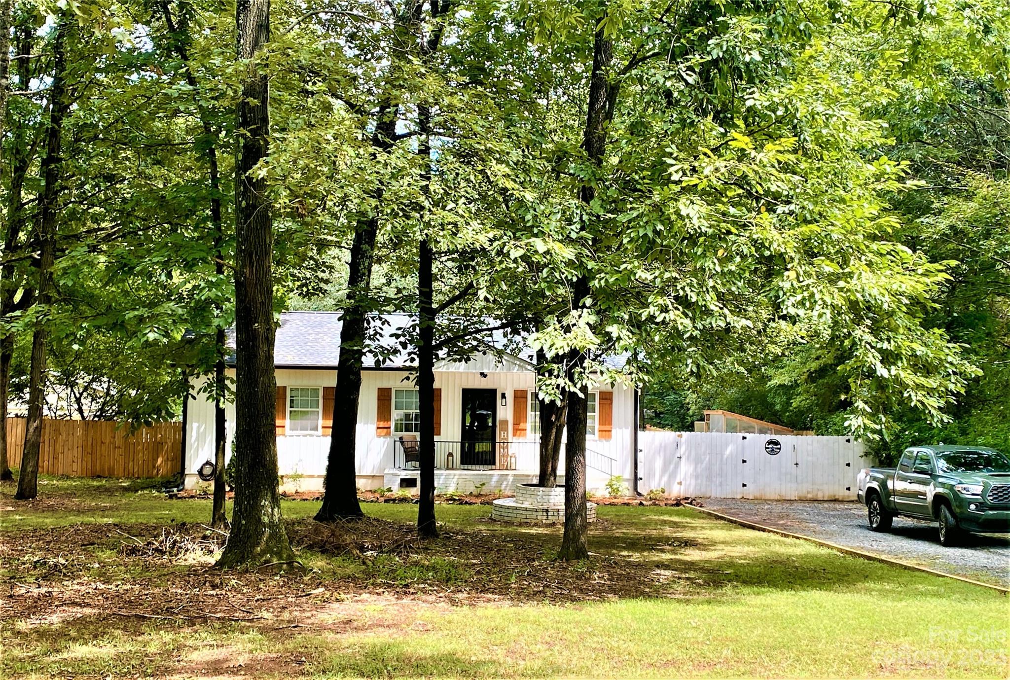 9701 Hambright Road Huntersville, NC 28078 - Photo 17 of 17 a front view of a house with a yard fountain and large tree