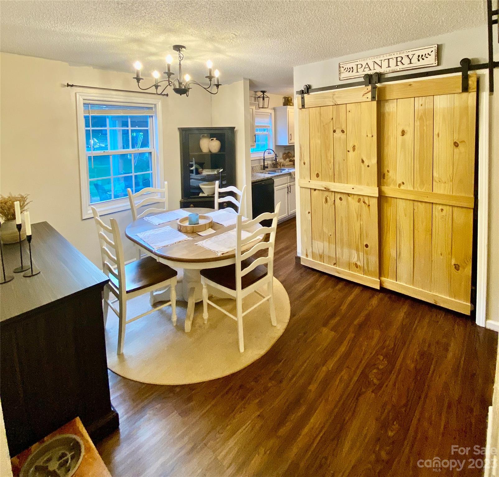 9701 Hambright Road Huntersville, NC 28078 - Photo 6 of 17 a view of a dining room with furniture a chandelier and wooden floor