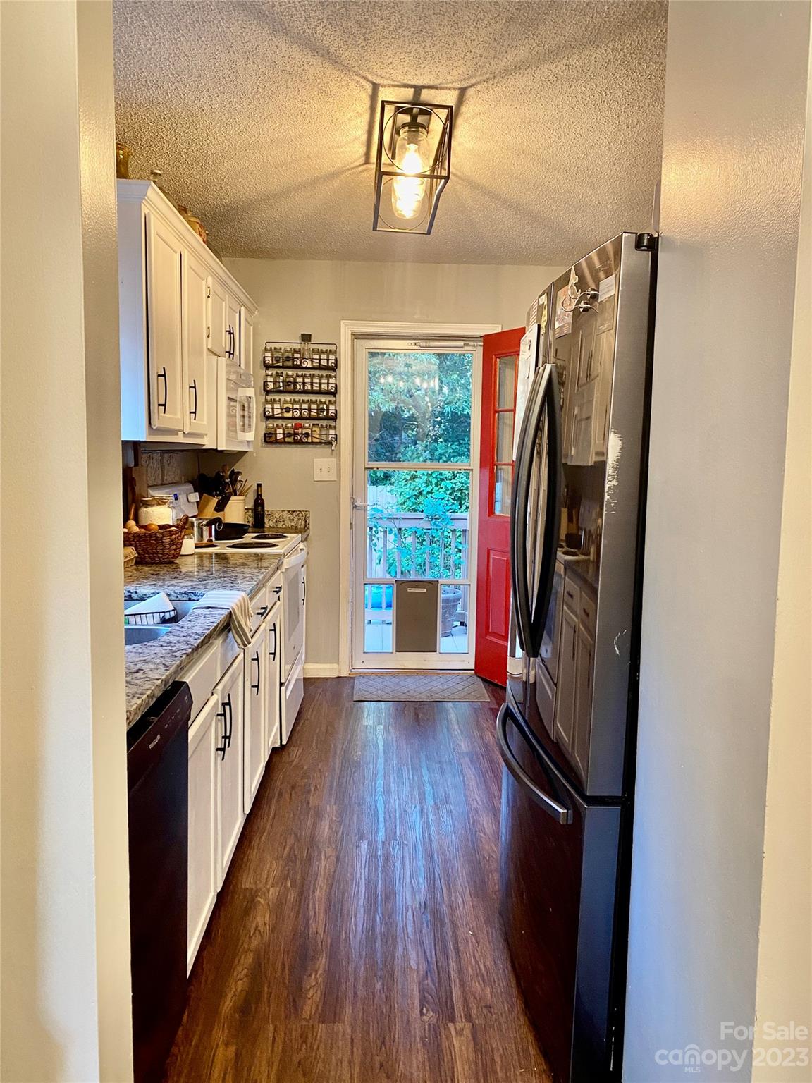 9701 Hambright Road Huntersville, NC 28078 - Photo 8 of 17 a kitchen with stainless steel appliances granite countertop a refrigerator a stove a sink dishwasher and wooden floor