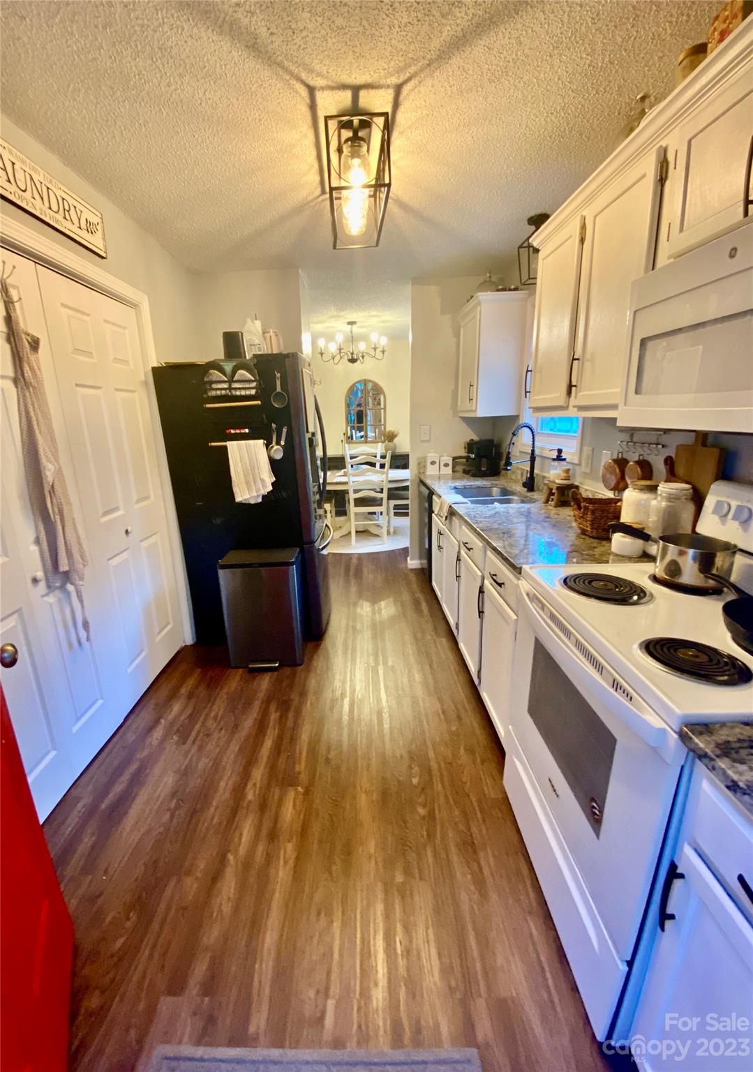 9701 Hambright Road Huntersville, NC 28078 - Photo 9 of 17 a kitchen with wooden floors and stainless steel appliances