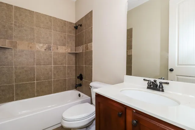 a bathroom with a sink a toilet and bathtub