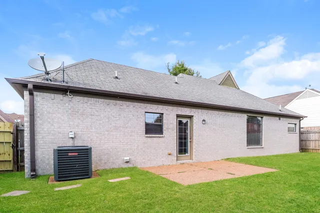 a backyard of a house with table and chairs
