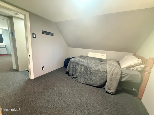 a bed room with a bed and a window