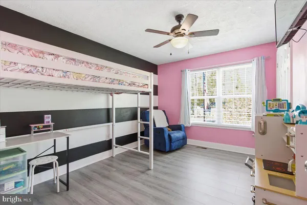 a bedroom with furniture and a window