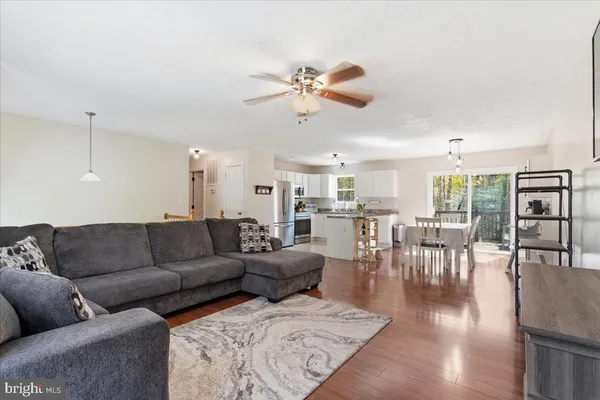 a living room with furniture and wooden floor