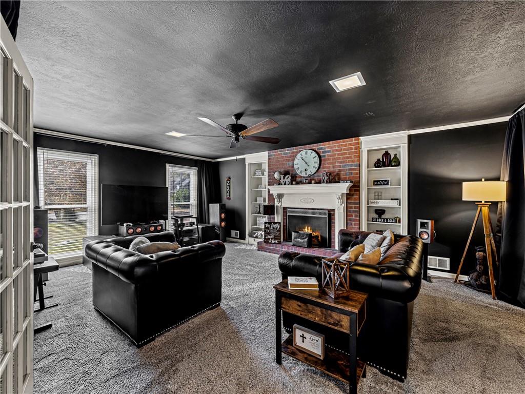 215 Pineywood Road Griffin, GA 30224 - Photo 13 of 49 a living room with furniture a flat screen tv and a fireplace