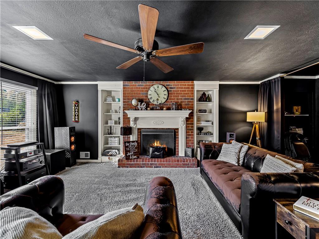 215 Pineywood Road Griffin, GA 30224 - Photo 14 of 49 a living room with furniture and a fireplace