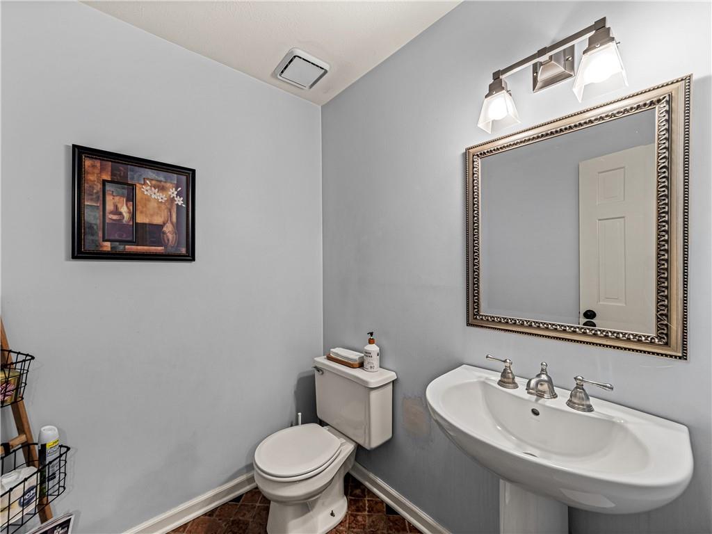 215 Pineywood Road Griffin, GA 30224 - Photo 17 of 49 a bathroom with a toilet a sink and mirror