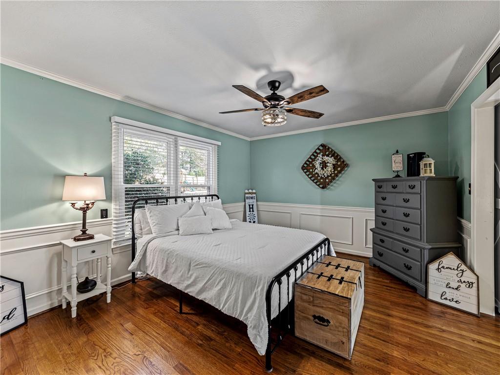 215 Pineywood Road Griffin, GA 30224 - Photo 19 of 49 a bedroom with a bed a chandelier and a dresser