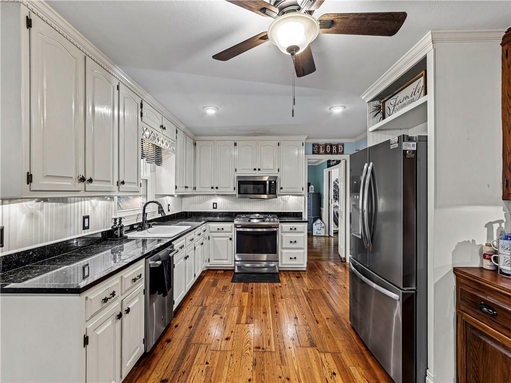 215 Pineywood Road Griffin, GA 30224 - Photo 22 of 49 a kitchen with stainless steel appliances a refrigerator a stove top oven and sink