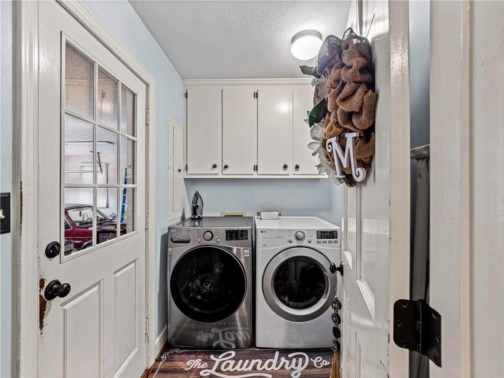 215 Pineywood Road Griffin, GA 30224 - Photo 26 of 49 a view of a storage and utility room with washer and dryer